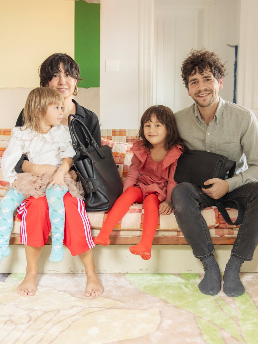Phoebe Sung and Peter Buer sitting on the couch with their daughters