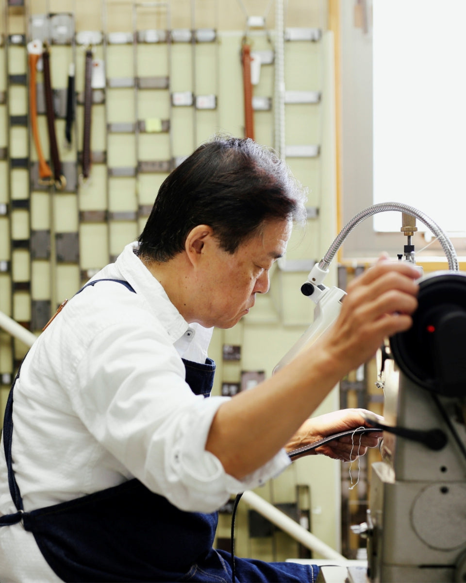 Person working on a machine in a workshop setting